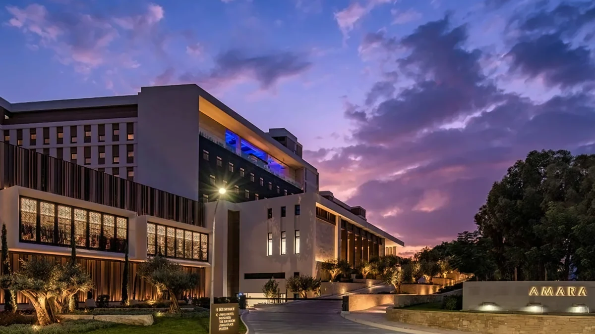 The Amara Hotel exterior showcasing modern architecture against a vibrant sunset sky in Cyprus.