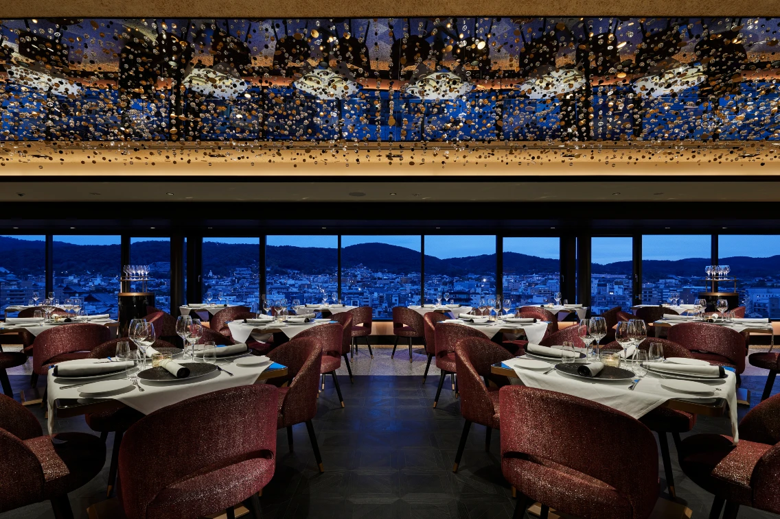 Elegant dining room in FAUCHON L’Hotel Kyoto with panoramic views, featuring plush chairs and intricate ceiling decor.