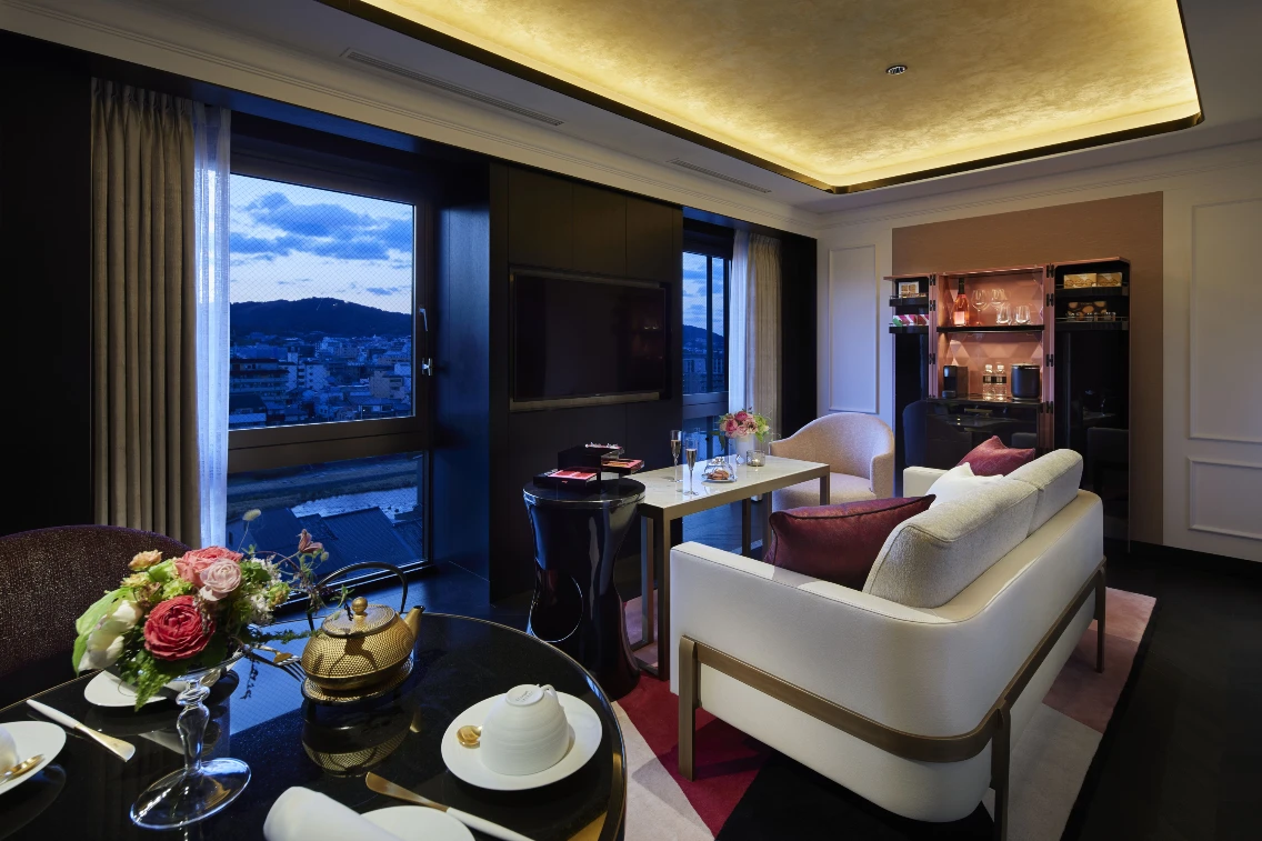 Luxurious hotel room at FAUCHON L’Hotel Kyoto featuring elegant furnishings, a dining area, and a scenic view.
