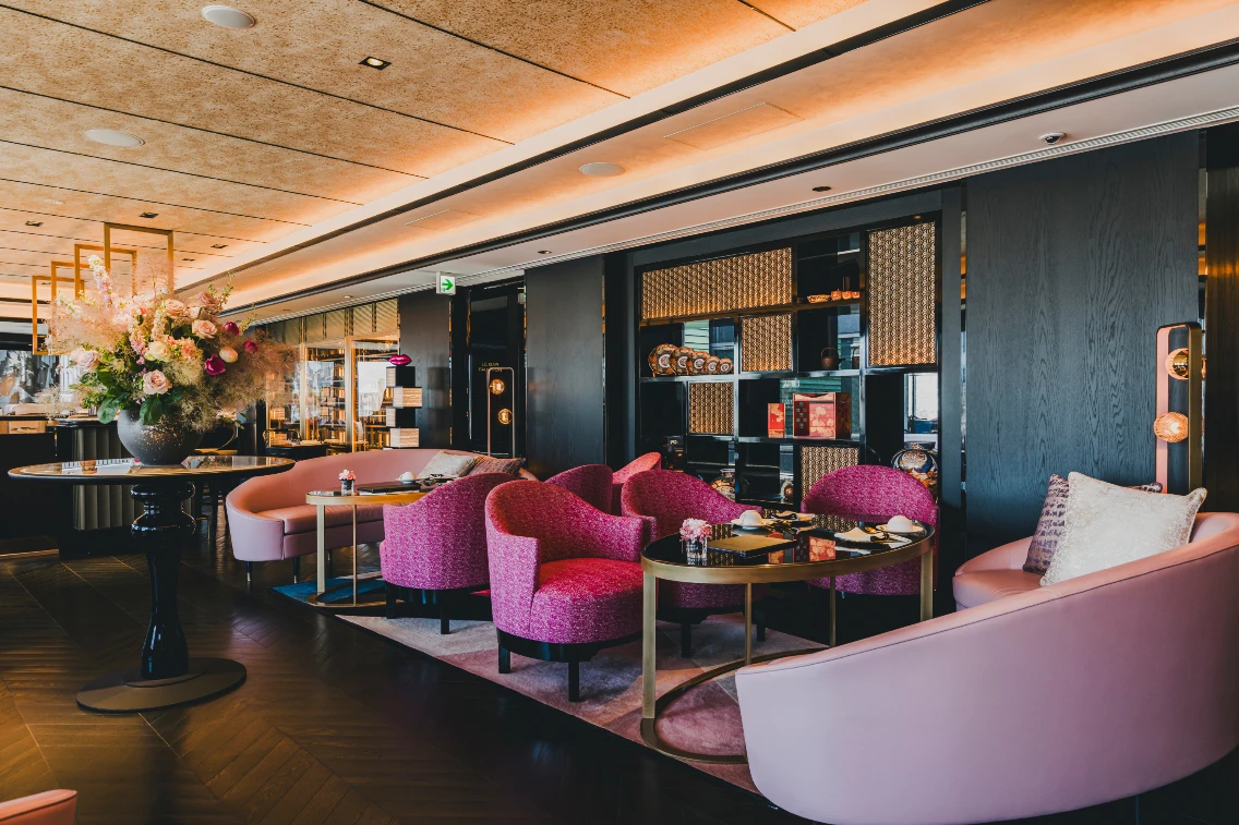 Elegant dining area at FAUCHON L’Hotel Kyoto featuring plush pink chairs, a stylish table, and vibrant floral arrangements.