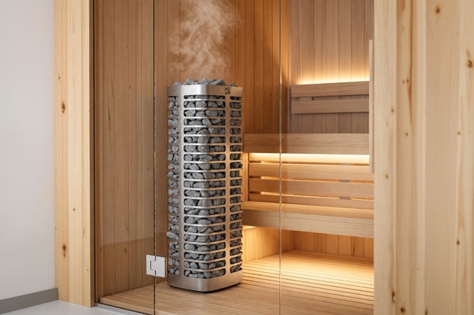 Luxury home sauna interior featuring a sleek, modern heater surrounded by wooden benches and soft lighting.