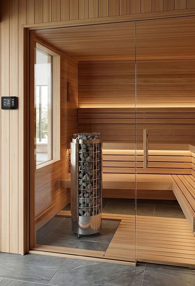 Modern sauna interior featuring wooden panels, a sleek heater with stones, and ambient lighting for a luxurious atmosphere.