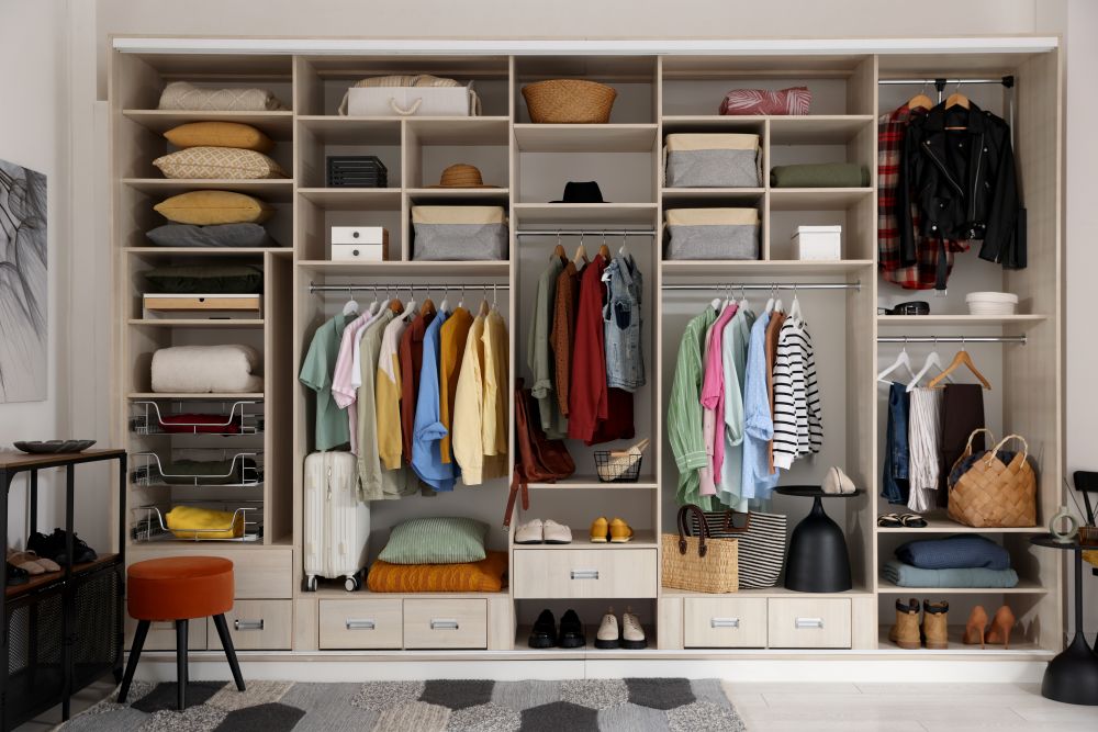 A well-organized wardrobe featuring neatly arranged clothing, accessories, and storage baskets, perfect for adding luxury to your style.
