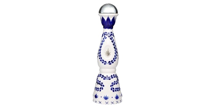 A decorative tequila bottle featuring intricate blue and white designs with an elegant round cap.