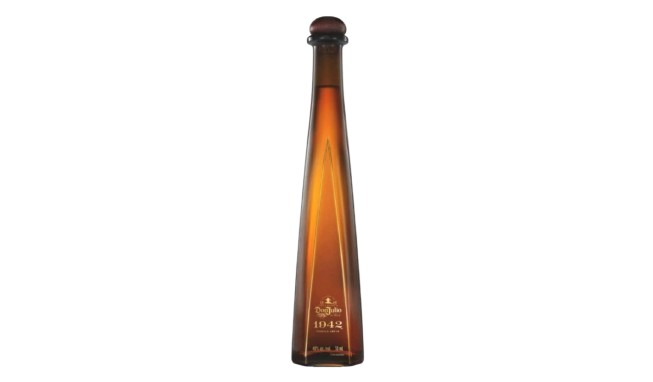 Elegant, elongated tequila bottle with a gradient amber color, featuring the label "Don Julio 1942" at the base.