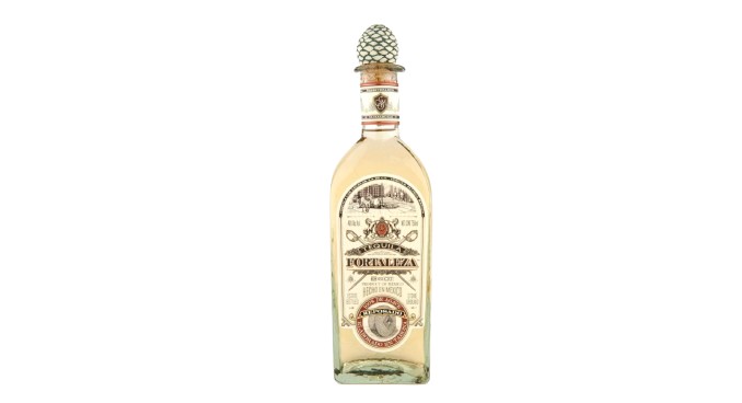 Tequila bottle of Fortaleza, featuring a decorative pineapple cap and vintage-style label.