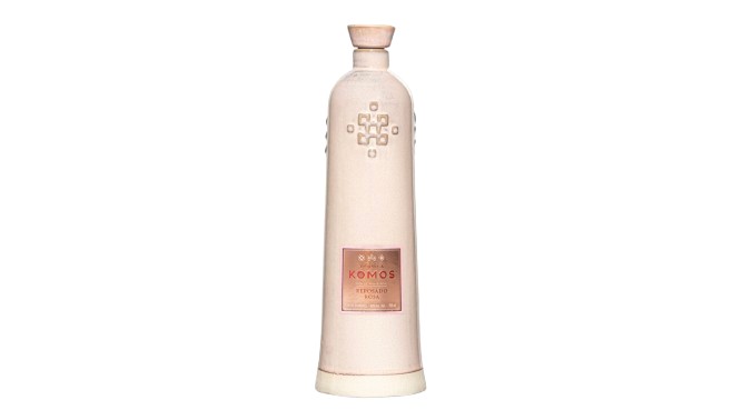 Ceramic tequila bottle with a unique design, labeled Komos Tequila, featuring a stylish cap and intricate detailing.