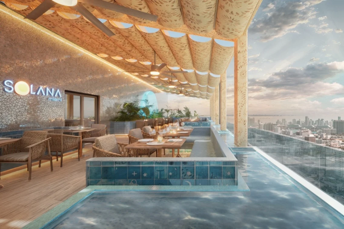Luxurious rooftop setting with dining area and pool, featuring modern decor and a panoramic view of Midtown Miami.