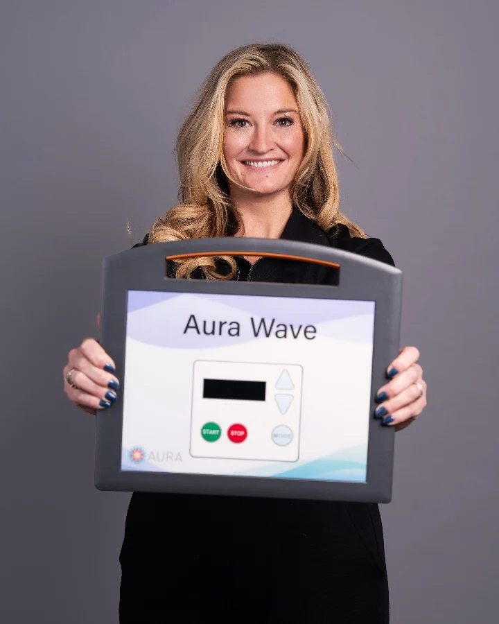 Alane Paulley, CEO of AuraWell, holds the FDA-cleared Aura Wave device designed for noninvasive prostate health.