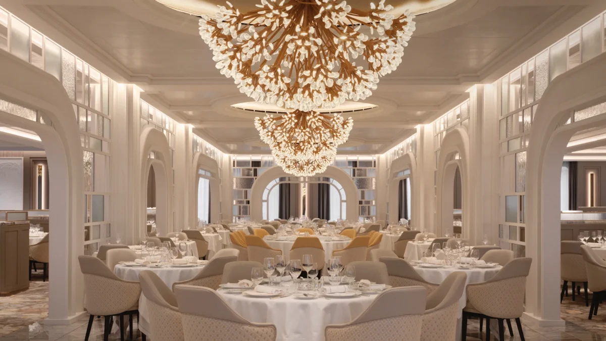 Elegant dining room featuring ornate chandeliers, beautifully set tables, and stylish seating arrangements.