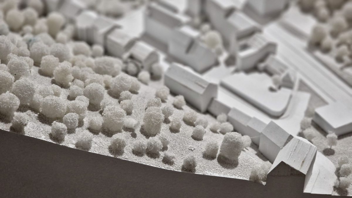 Model of a property landscape featuring white structures and textured elements, symbolizing investment opportunities for portfolio growth.