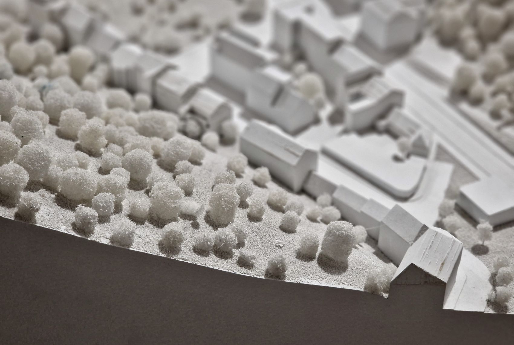 Model of a property landscape featuring white structures and textured elements, symbolizing investment opportunities for portfolio growth.