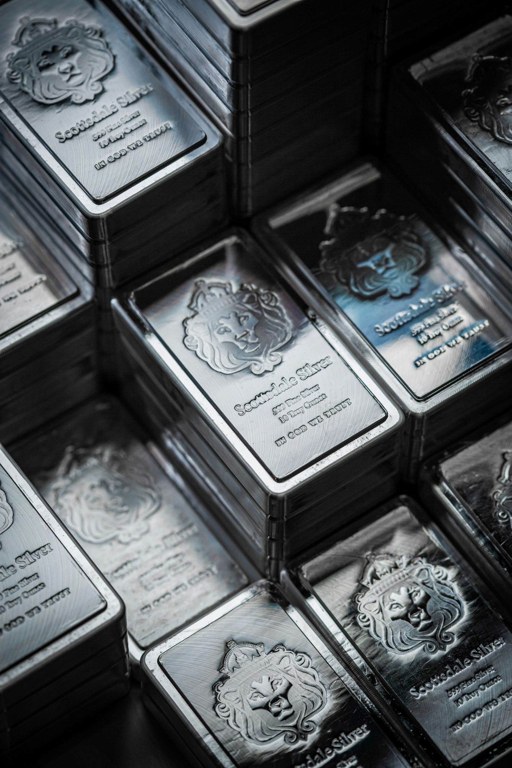 Scottsdale silver bars stacked neatly, showcasing their polished surfaces and detailed branding.