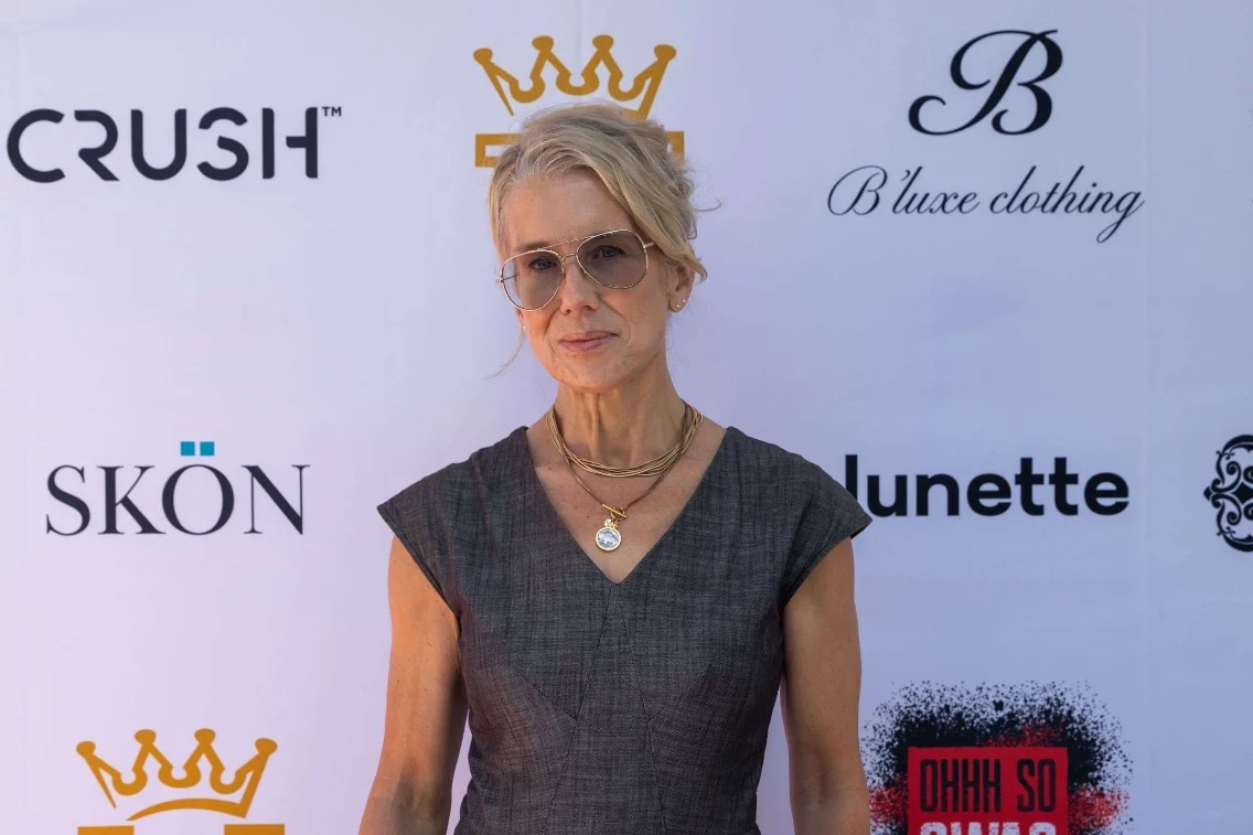 Lauren Weedman poses at the DRAFT 2026 Emmy Nominees gifting lounge event against a branded backdrop.