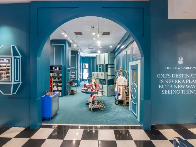 The Ritz-Carlton shop entrance at Bloomingdale's features a turquoise interior and a quote about new perspectives.