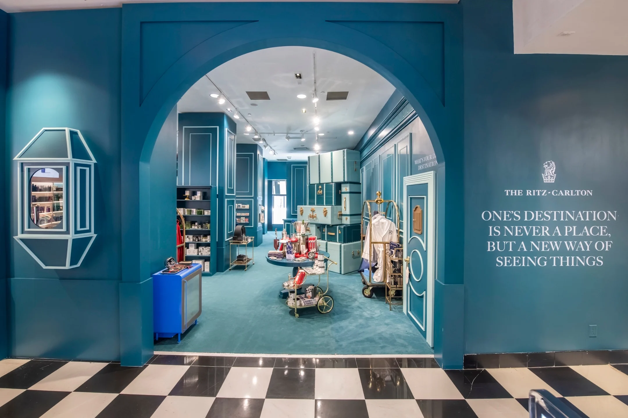 The Ritz-Carlton shop entrance at Bloomingdale's features a turquoise interior and a quote about new perspectives.