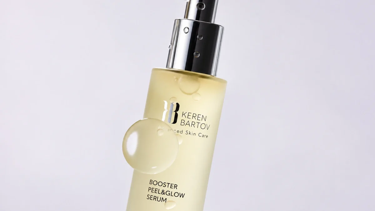 Keren Bartov Booster Peel & Glow Serum in a sleek bottle, promoting radiance and skin renewal with a glossy drop visible.