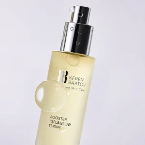 Keren Bartov Booster Peel & Glow Serum in a sleek bottle, promoting radiance and skin renewal with a glossy drop visible.