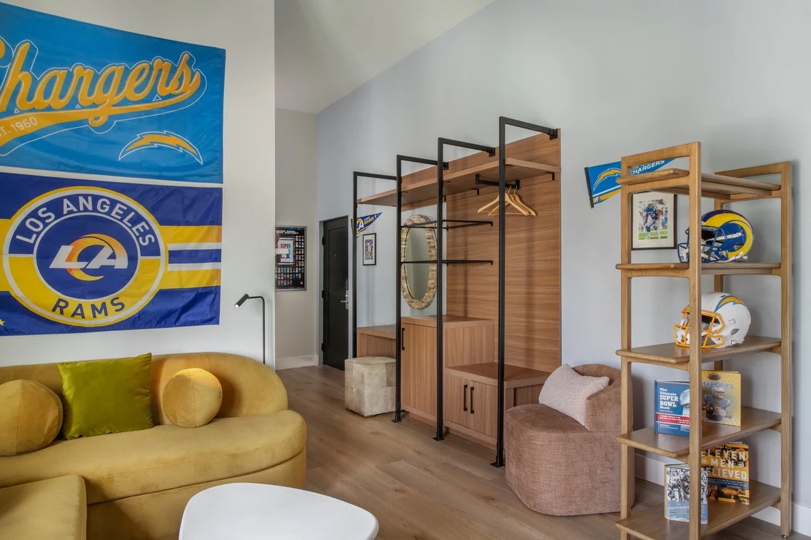 Bright, inviting space featuring Los Angeles Chargers and Rams decor, a cozy seating area, and stylish storage solutions.