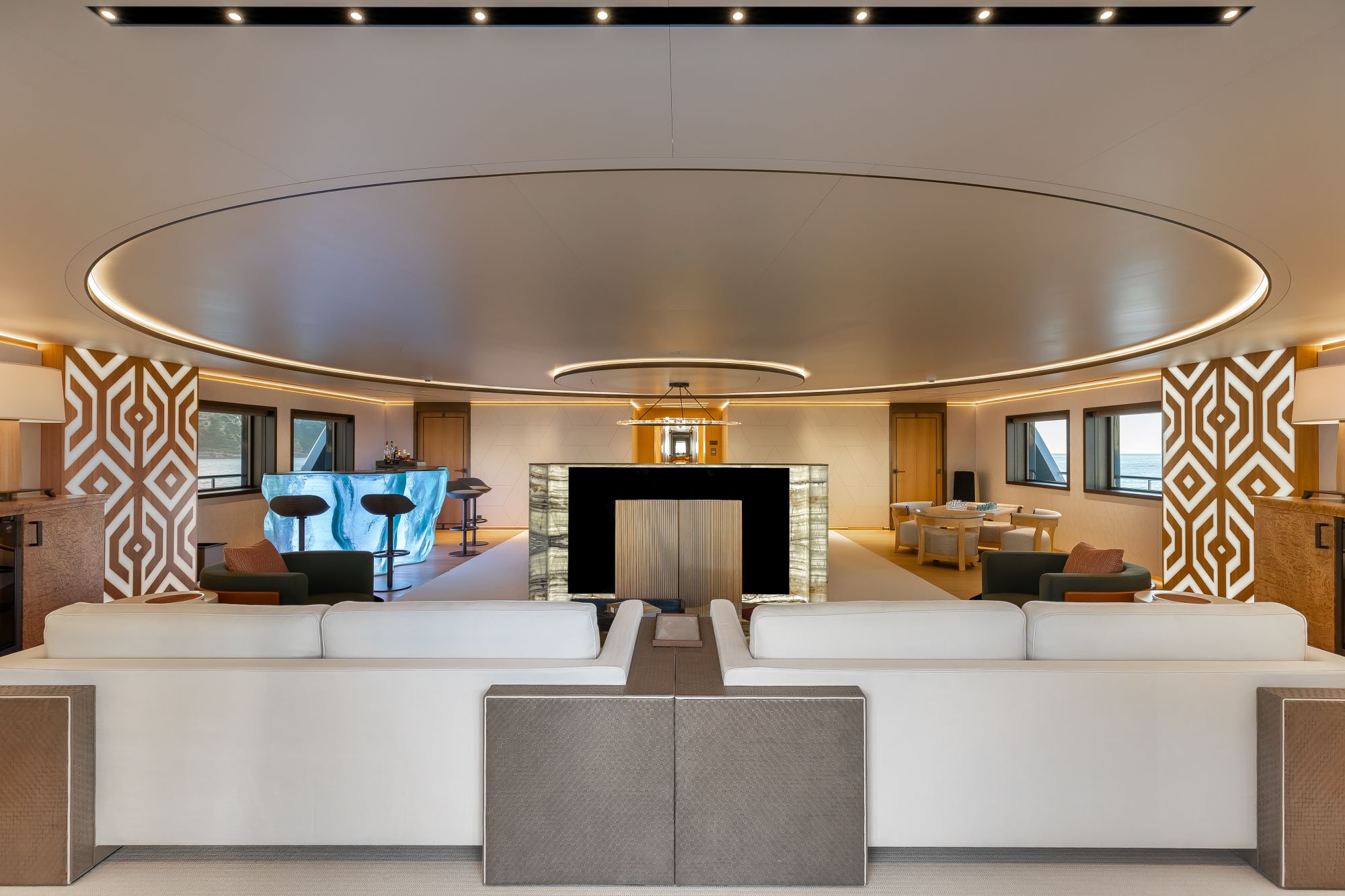 Luxurious interior of LA DATCHA yacht featuring elegant furnishings, a stylish bar, and ambient lighting.