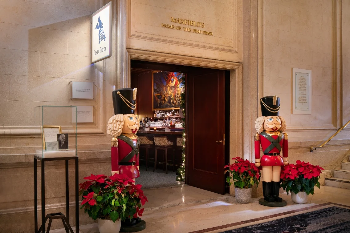 Entrance to Pied Piper restaurant adorned with festive nutcracker figures and poinsettias, welcoming guests for the holiday season.