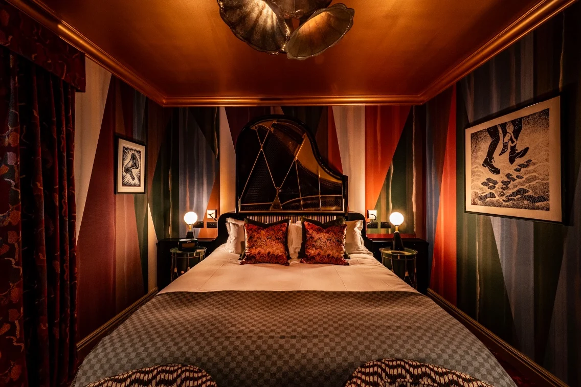 Luxurious guest room at Ardbeg House featuring bold colors, a patterned bedspread, and stylish decor elements.