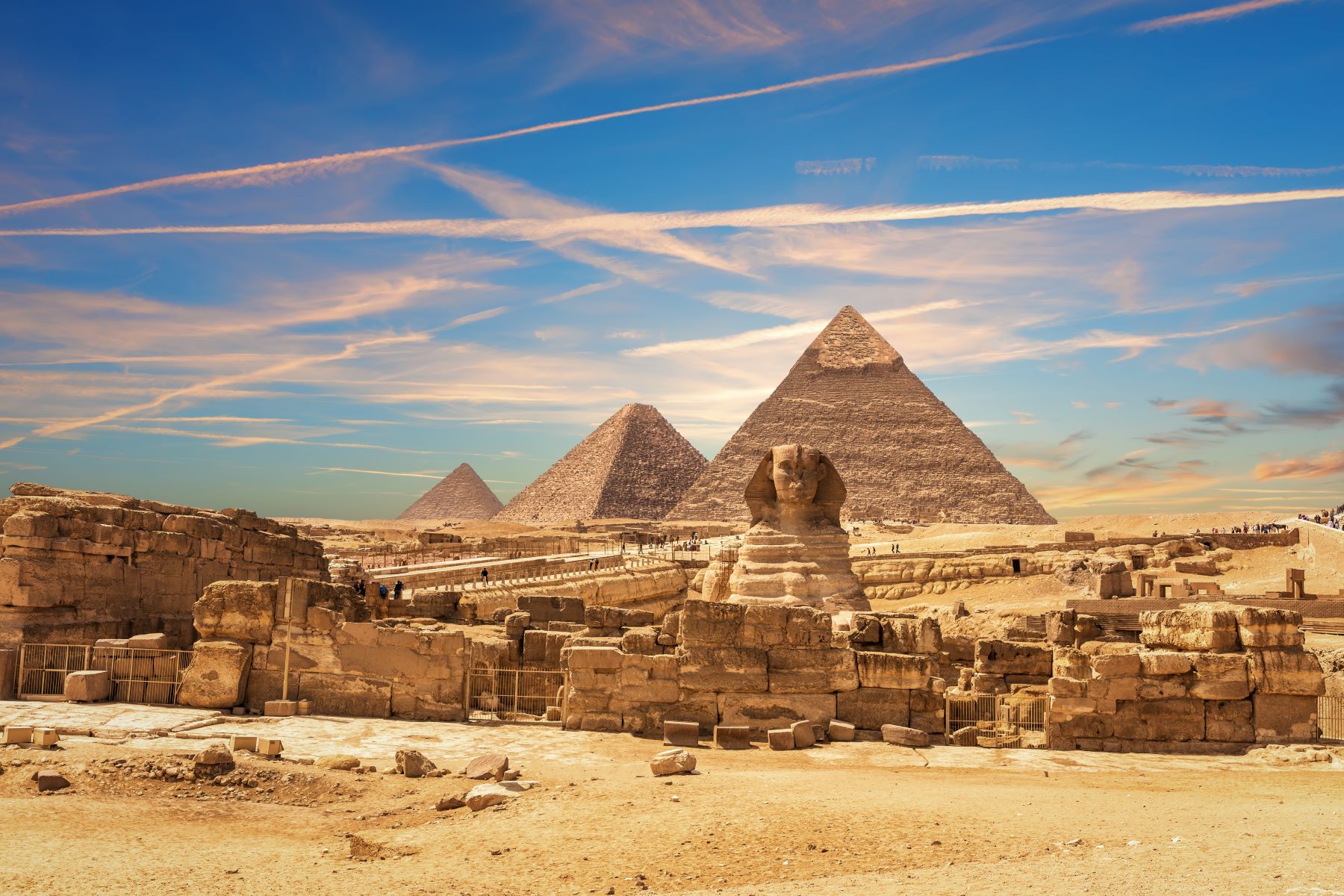 The Great Sphinx and pyramids of Giza under a clear sky, highlighting Egypt's rich history and architectural marvels.