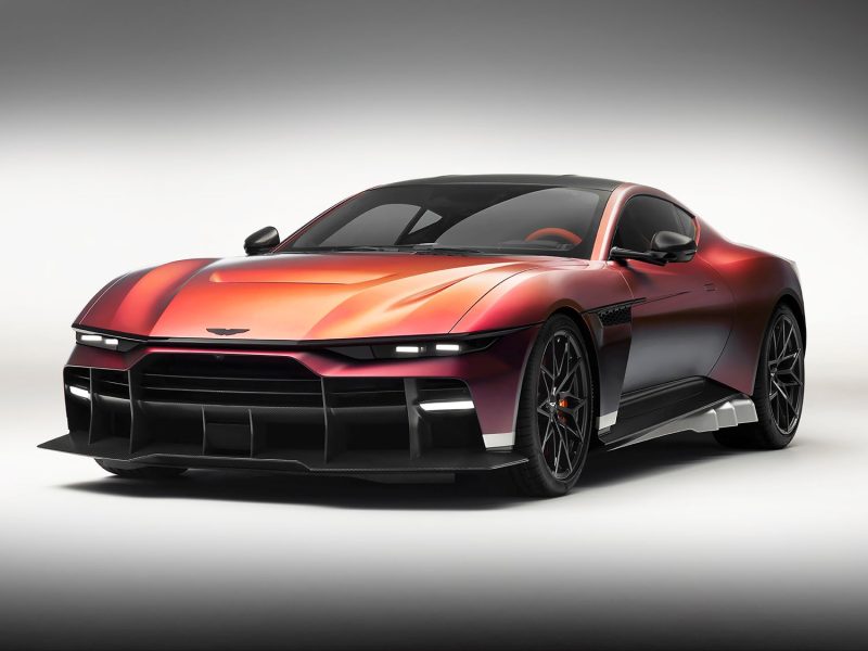 Aston Martin Valen showcasing a sleek design with a vivid red exterior and aggressive stance, highlighting its V12 supercar performance.