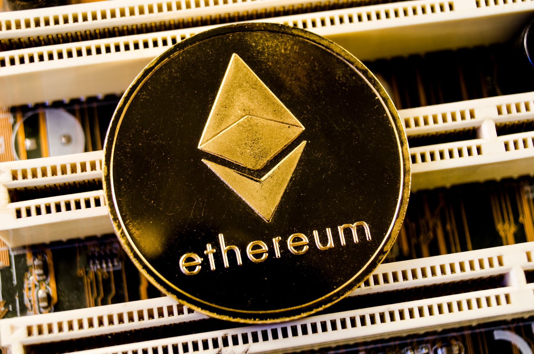 Ethereum coin displayed on a circuit board background, representing cryptocurrency technology and blockchain applications.