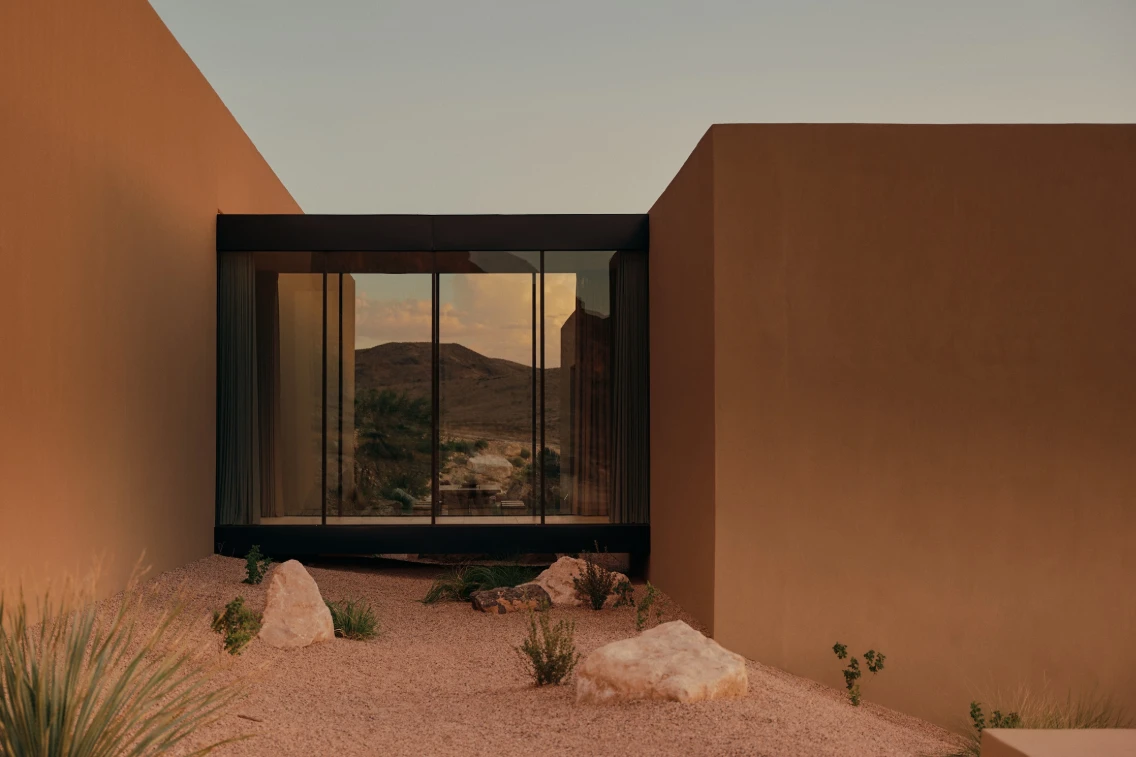A sculptural retreat in Southern Utah blending architecture with desert landscape, featuring glass walls and natural elements.