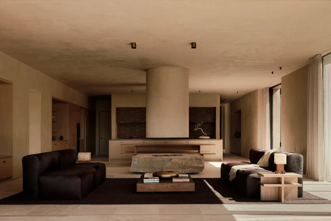 Sleek interior design of a desert retreat featuring a spacious living area with earthy tones and modern furnishings.