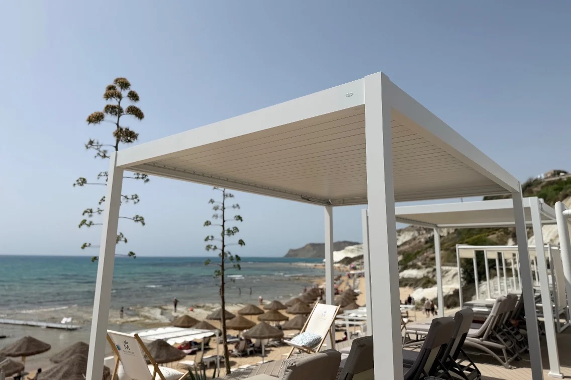 Lounge area with white canopies overlooking the beach and sea at Rocco Forte's Verdura Resort in Sicily.