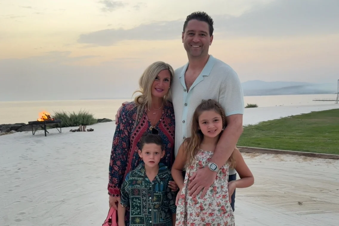 Family enjoying a scenic beach sunset at Rocco Forte’s Verdura Resort, with a fire pit visible in the background.