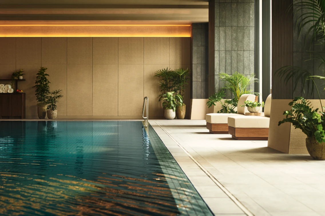Indoor swimming pool at 1 Hotel Tokyo, featuring sleek design, lush plants, and a relaxing ambiance.