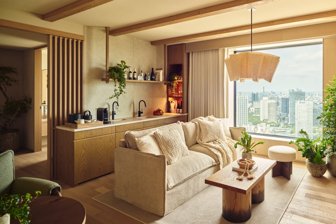 Stylish junior suite in 1 Hotel Tokyo featuring a cozy living area, kitchenette, and panoramic city views.