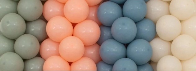Colorful latex balloons in pastel shades of pink, blue, green, and white arranged in a decorative pattern.