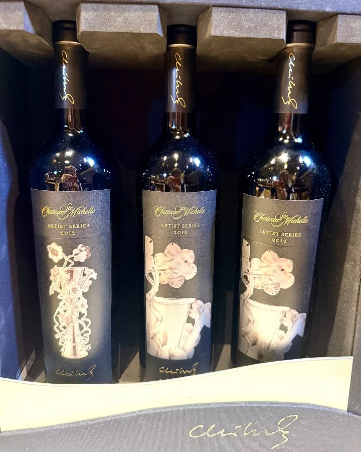 Three bottles of Chateau Ste. Michelle's Artist Series wine, elegantly displayed in a protective box, featuring artistic labels.