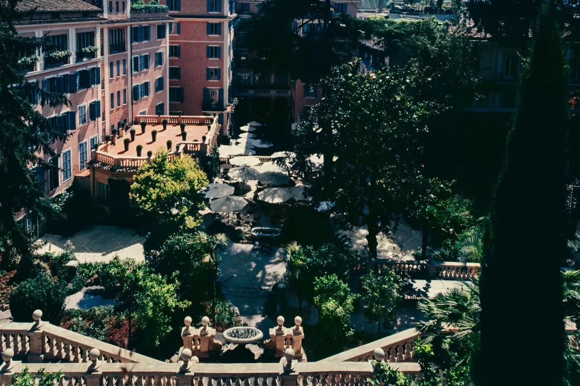 View of the serene Secret Garden at Hotel de Russie, featuring lush greenery and elegant seating areas.