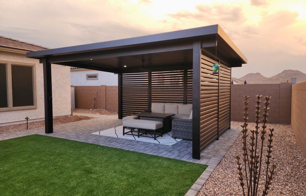 Outdoor room featuring a modern pergola, cozy seating area, and landscaped gravel, symbolizing luxury and comfort.