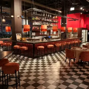 Interior of Christian's Wine Bar featuring a stylish bar, seating areas, and a striking checkerboard floor design.