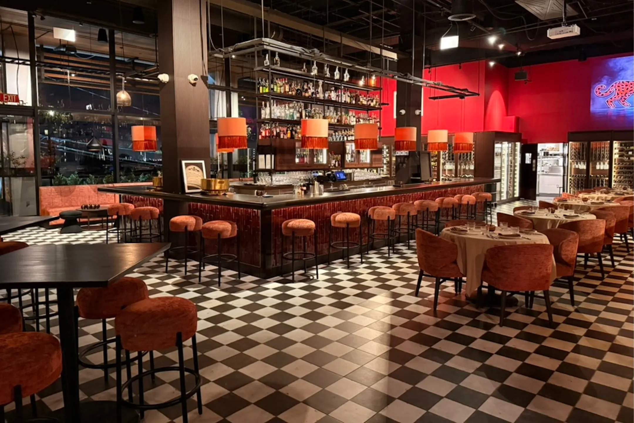 Interior of Christian's Wine Bar featuring a stylish bar, seating areas, and a striking checkerboard floor design.