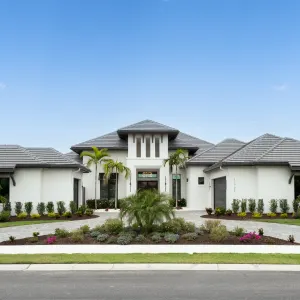 Modern home with palm trees and flower gardens in a serene Florida setting, emphasizing private boating access and preserve views.