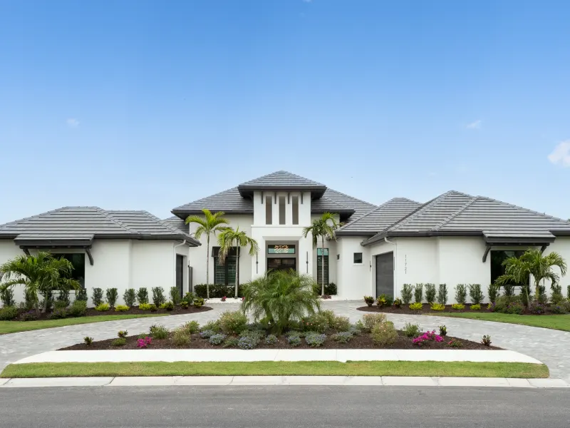 Modern home with palm trees and flower gardens in a serene Florida setting, emphasizing private boating access and preserve views.