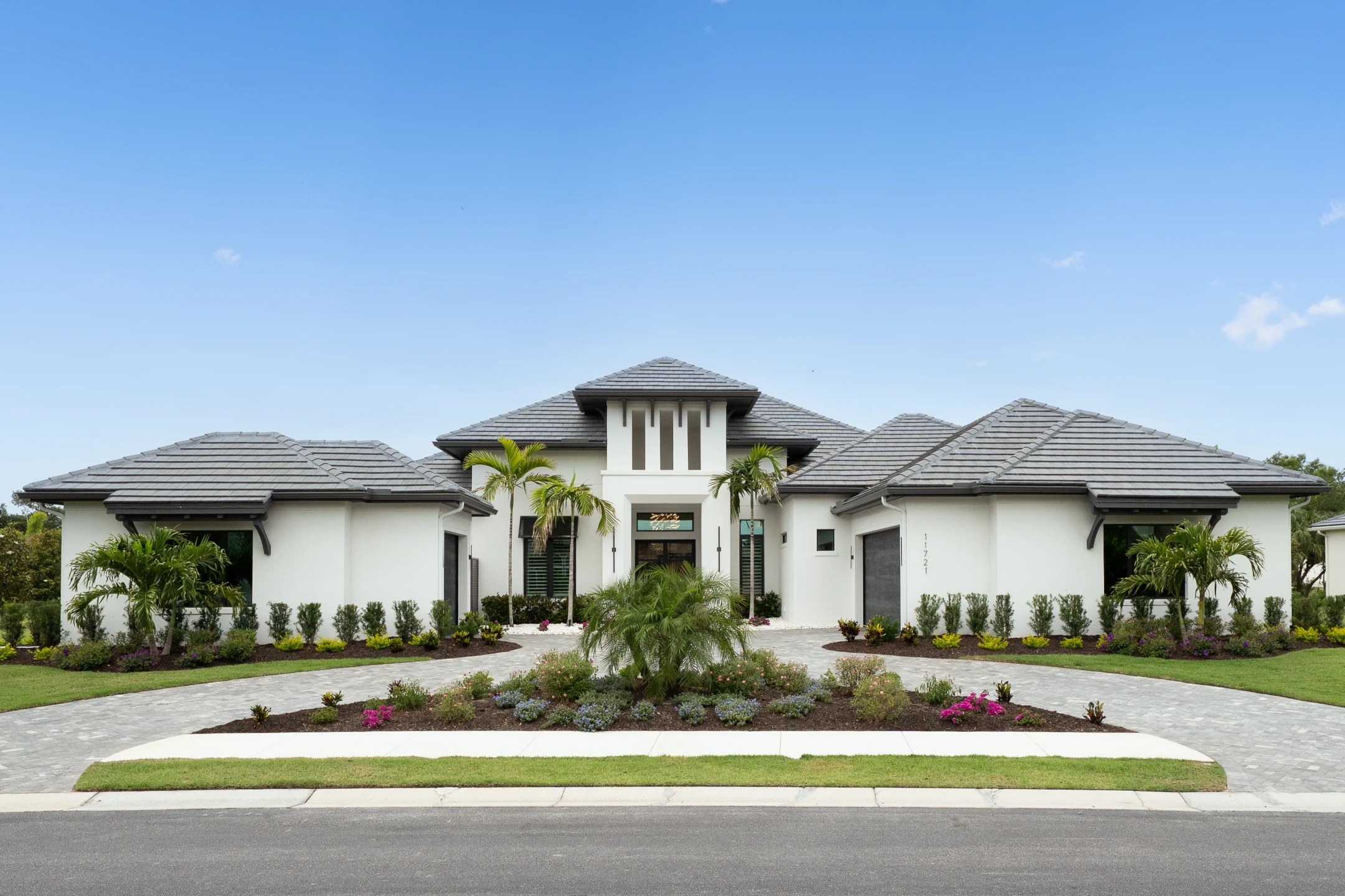 Modern home with palm trees and flower gardens in a serene Florida setting, emphasizing private boating access and preserve views.