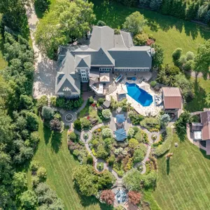 Aerial view of a spacious property featuring a landscaped garden, pool, and a large home in Richfield, Ohio.