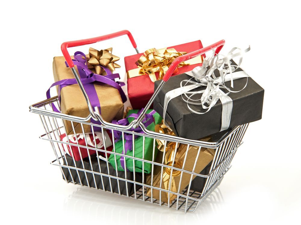 A shopping basket filled with beautifully wrapped gift boxes in various colors and ribbon styles.