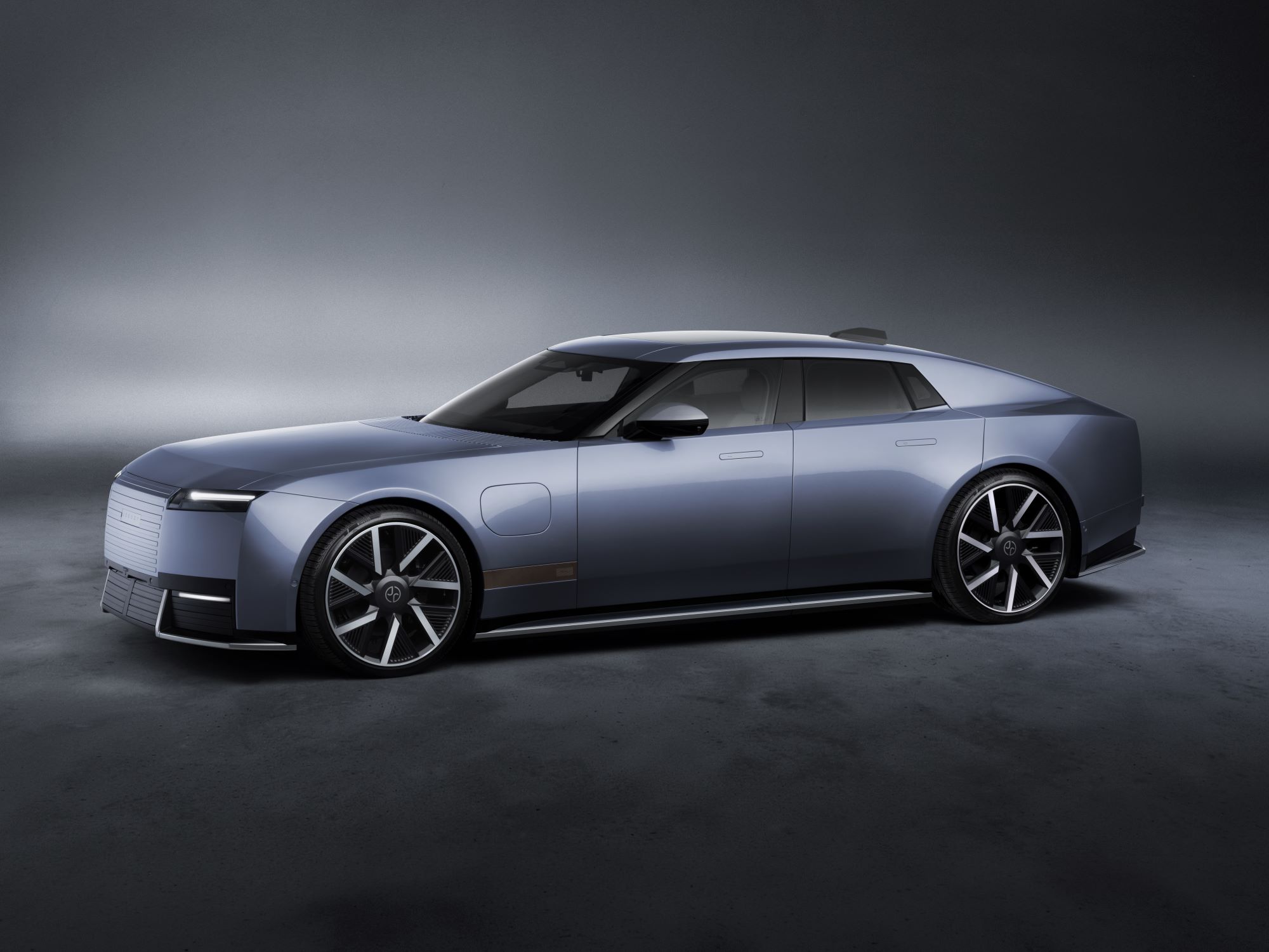 Jaguar Type 01 in a sleek blue finish, showcasing luxury design and performance features in a dimly lit studio setting.