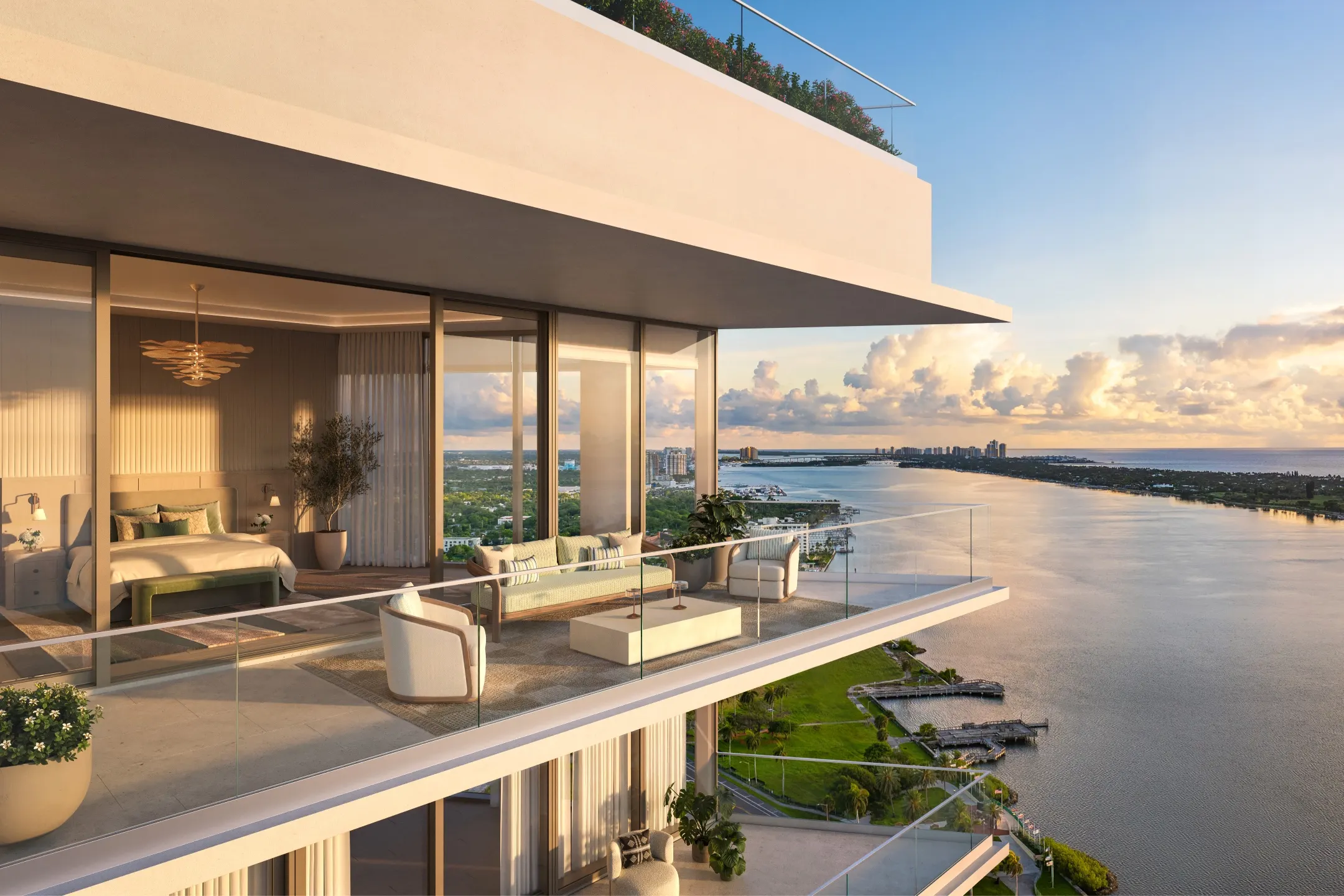 Luxury penthouse terrace overlooking the water, featuring modern furniture and a scenic sunset view in West Palm Beach.