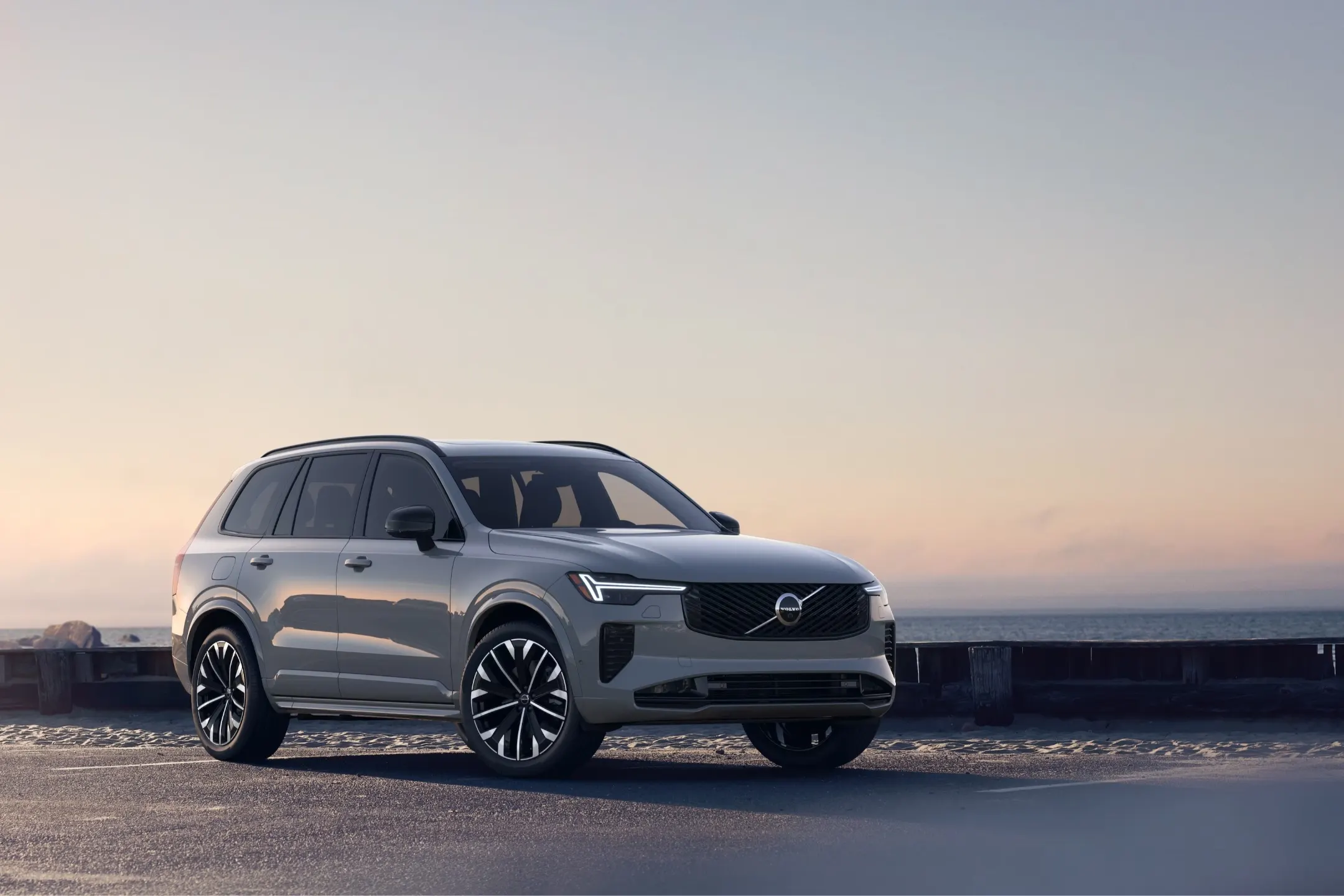 2026 Volvo XC90 T8 Ultra showcased from the front right in a coastal setting with a serene background.