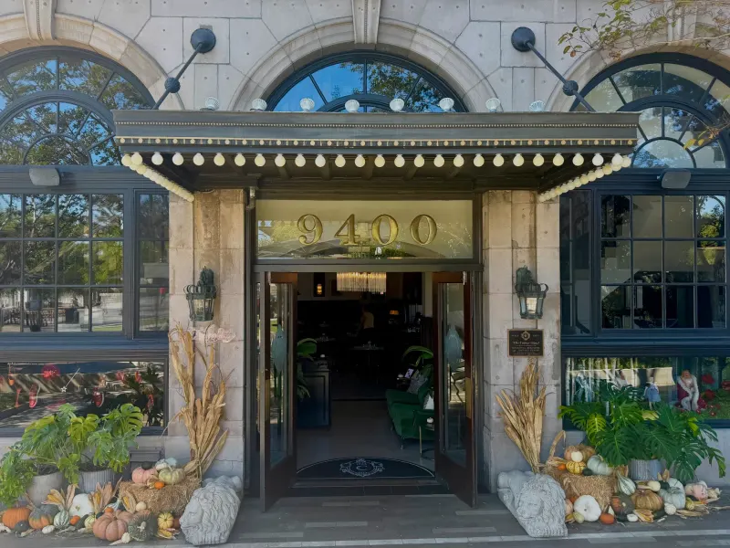 The entrance of the Culver Hotel decorated with pumpkins and cornstalks for a gothic Halloween theme.
